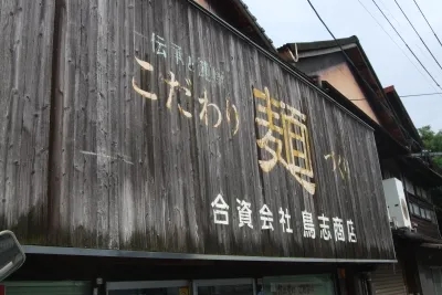 歴史を感じる老舗の看板に「こだわり麺」の文字